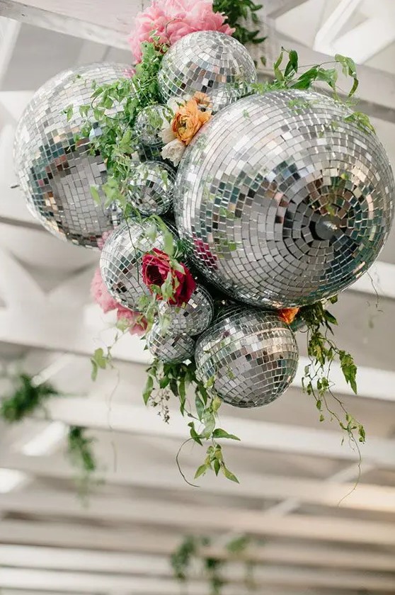 a bold wedding decoration of disco balls, bright blooms and greenery is a stylish and cool idea to rock