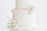 37 a white wedding cake decorated with sugar patterns, white sugar trees on top and white poinsettias is a lovely idea for Christmas