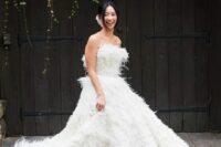 39 a feather strapless wedding ballgown with a train is a fantastic and extra bold solution for a modern and refined bride