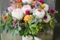 40 a cheerful summer wedding bouquet of blush peony roses, yellow blooms, thistles, bold and colorful flower touches and greenery