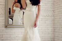 40 an off the shoulder mermaid wedding dress with a belt and a feathered skirt is a very sophisticated solution