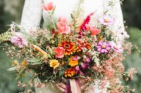 41 a colorful and textural fall wedding bouquet of pink and hot pink blooms, orange ones and lots of blooming branches