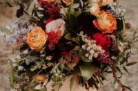 42 a colorful fall wedding bouquet of orange, pink, red, blue, lilac blooms, foliage and greenery is a catchy fall wedding solution