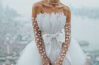 44 a bold bridal look with a trapless A-line mini dress with a bow, sheer floral long gloves and a pearl necklace