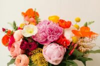 46 a colorful wedding bouquet with red poppies, peachy and yellow ranunculus, pink peonies, pincushion proteas and foliage