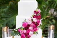 a cute white wedding cake with blooms