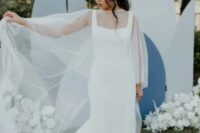 49 a minimalist sheath wedding dress with thick straps and a pearl capelet that makes the bridal look more girlish and glam