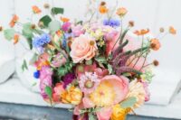 51 a fantastic colorful wedding bouquet with pink peonies, poppies and ranunculus, blue and orange touches and astilbe