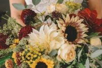 53 a sumptuous fall wedding bouquet of burgundy and neutral dahlias, peony roses, sunflowers, greenery and dark foliage