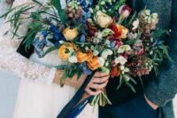 61 a bright wedding bouquet of bold blue, yellow, burgundy and neutral blooms, greenery and berries plus ribbons