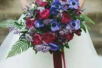 62 a fantastic and bold fall wedding bouquet with purple anemones, burgundy roses and lilac blooms, greenery and foliage