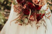 67 a vibrant fall wedding bouquet of pink and burgundy blooms, greenery and bold fall foliage, grasses and dried blooms is amazing