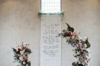 a beautiful wedding ceremony space with a fantastic foam free floral altar made with neutral and pink blooms, greenery and leaves plus a cool backdrop