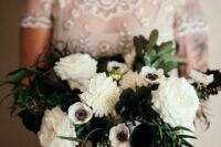 a black and white wedding bouquet of white dahlias and anemones, black callas and berries and some greenery for a modern bride