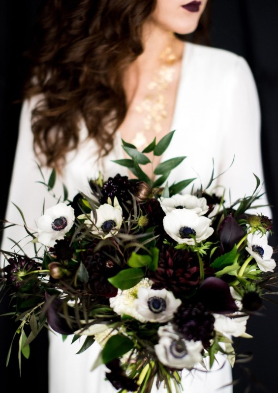 a bold and contrasting wedding bouquet of white anemones and dark dahlias, greenery and textural dark foliage is wow