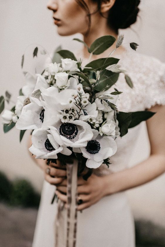a chic modern wedding bouquet of white roses, anemones, some grasses and foliage is a lovely idea for a modern bride