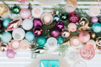 a colorful and glitter ornament table runner on fir branches and ornaments for each place setting are great for a colorful NYE wedding