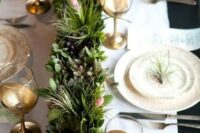 a cute and natural centerpiece of a wooden box with moss, evergreens, succulents and little blooms for a winter or Christmas wedding