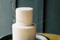 a minimalist neutral wedding cake with texture and a bit of twigs is a stylish idea for the fall or winter