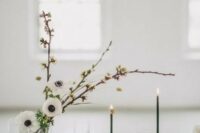 a stylish minimalist wedding centerpiece composed of blooming branches and white anemones is a lovely idea for a neutral wedding