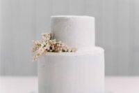 a white textural wedding cake decorated with a bit of berries and nothing else is a lovely idea for a minimalist wedding