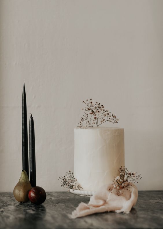 a white textural wedding cake topped with a bit of berries and dried twigs is a beautiful idea for fall and winter
