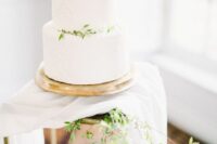 a white textural wedding cake topped with greenery is a beautiful idea for spring and summer weddings