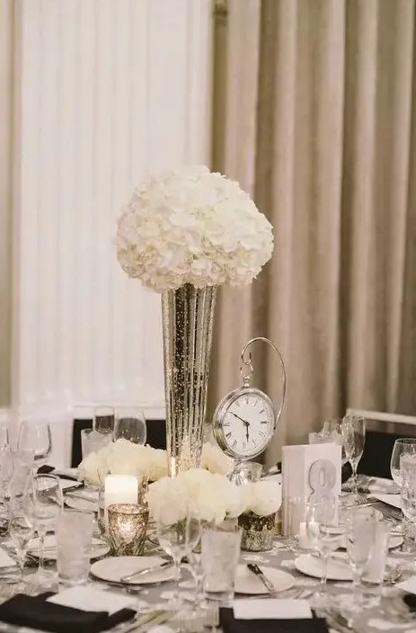 an elegant black and white tablescape with a clock to remind is a cool and stylish idea for a NYE wedding