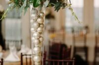 a tall wedding centerpiece filled with ornaments