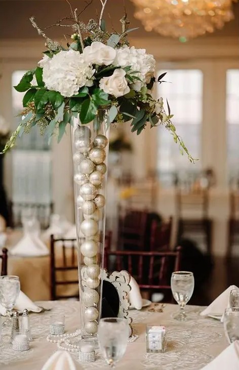 a tall wedding centerpiece filled with ornaments
