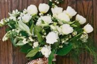 04 a white wedding bouquet of smaller and larger blooms and much greneery for a textural touch