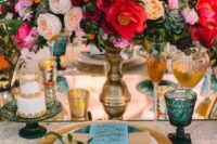 07 a bold jewel-tone wedding table setting with pink, red, peachy and yellow blooms and succulents, blue glasses, gold touches