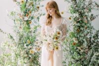 07 a fantastic wedding arch covered with greenery, white and yellow blooms and blooming branches is a perfect idea for spring