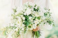08 a dimensional white wedding bouquet with a cascading part and greenery for a chic and romantic look