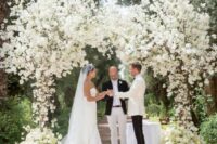 11 a gorgeous lush wedding arch covered with white blooms and blooming branches is a fantastic idea for any formal wedding