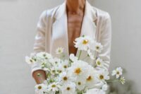 11 a modern white wedding bouquet with no greenery will match a modern or minimalist bridal look