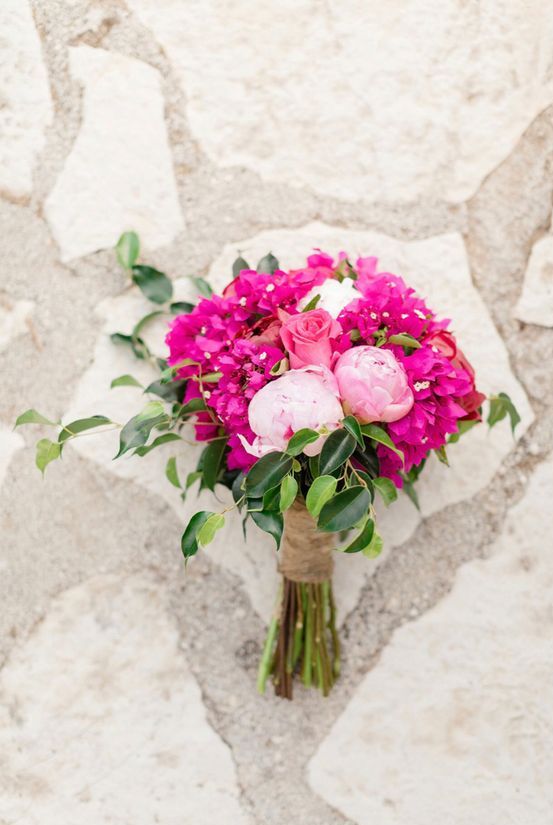 a bright wedding bouquet with bougainvillea, pink peonies and a pink rose is a cool bold idea for a wedding