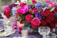 12 a fab jewel tone wedding centerpiece of red, deep red, hot pink, violet blooms, privet berries and greenery is a chic idea