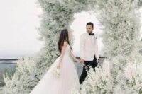 12 a jaw-dropping wedding arch that feels like a cloud as it’s fully covered with white baby’s breath is amazing