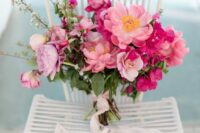 13 a beautiful pink wedding bouquet composed of pink peonies and fuchsia bougainvillea plus greenery