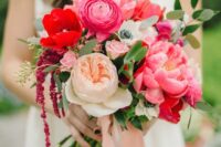 16 a bold wedding bouquet of pink peonies and ranunculus, neutral peony roses and red anemones and some greenery