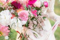 17 a lush and dimensional pink wedding bouquet with white, light pink and hot pink blooms, berries and greenery plus ribbons