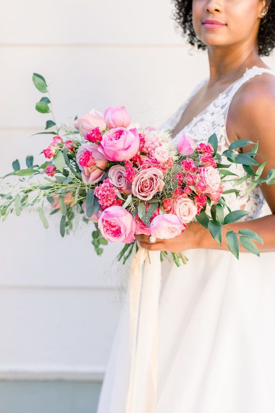 a pink wedding bouquet of roses, peony roses and carnations plus greenery is a gorgeous idea for a bold wedding