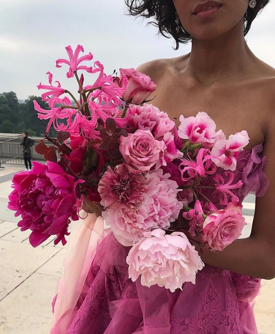 a beautiful all-pink wedding bouquet with light, hot pink blooms, burgundy and blush ones to create a unique monochromatic look