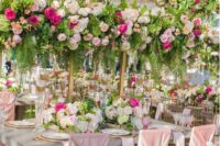 20 a beautiful flower-filled wedding reception with tall bold floral centerpieces and usual ones as a match looks amazing