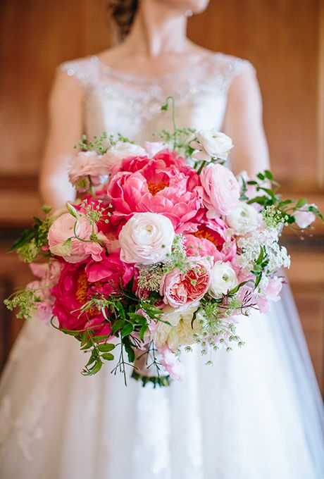 a pink wedding bouquet with light and hot pink blooms and greenery is an amazing touch of color