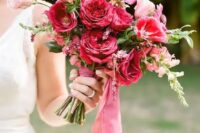 23 a vibrant wedding bouquet with pink and fuchsia and red blooms and berry-hued ribbons is amazing for a bold wedding