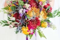 25 a bold wedding bouquet with yellow, burgundy, purple blooms, greenery, astilbe and purple ribbons is fun