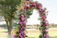 25 a fabulous wedding arch with peachy, orange and hot pink blooms, greenery and frinds is a lovely idea for a bright wedding