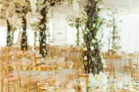 25 a fantastic wedding reception space with oversized centerpieces that imitate blooming trees looks jaw-dropping